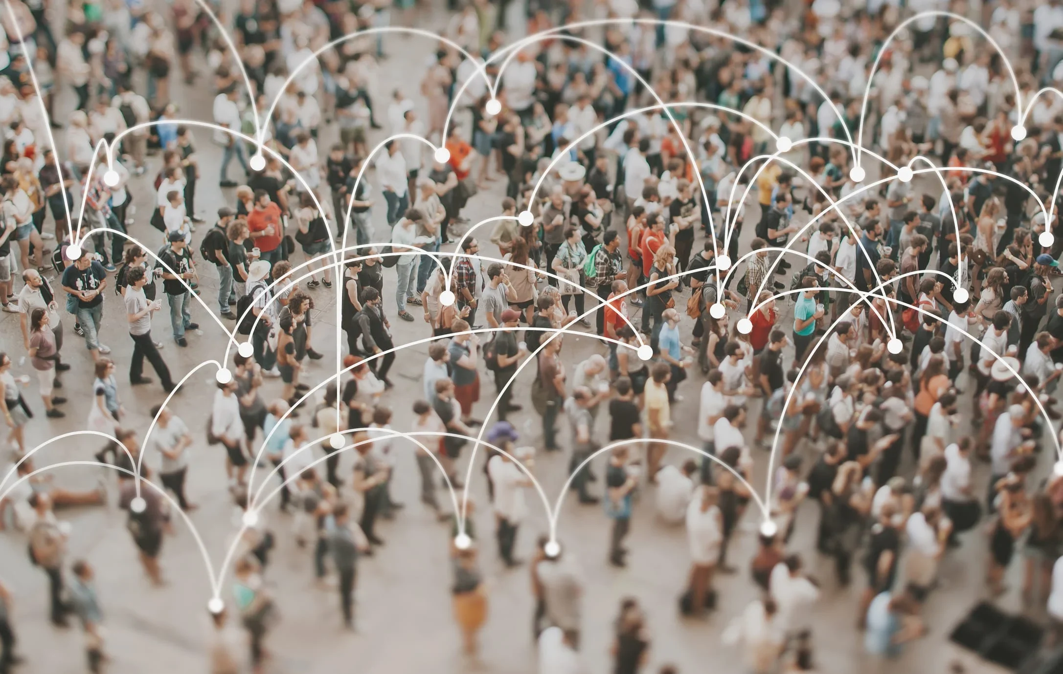 A diverse crowd of people with white dotted lines connecting them, illustrating the concept of expanding one's sphere of influence