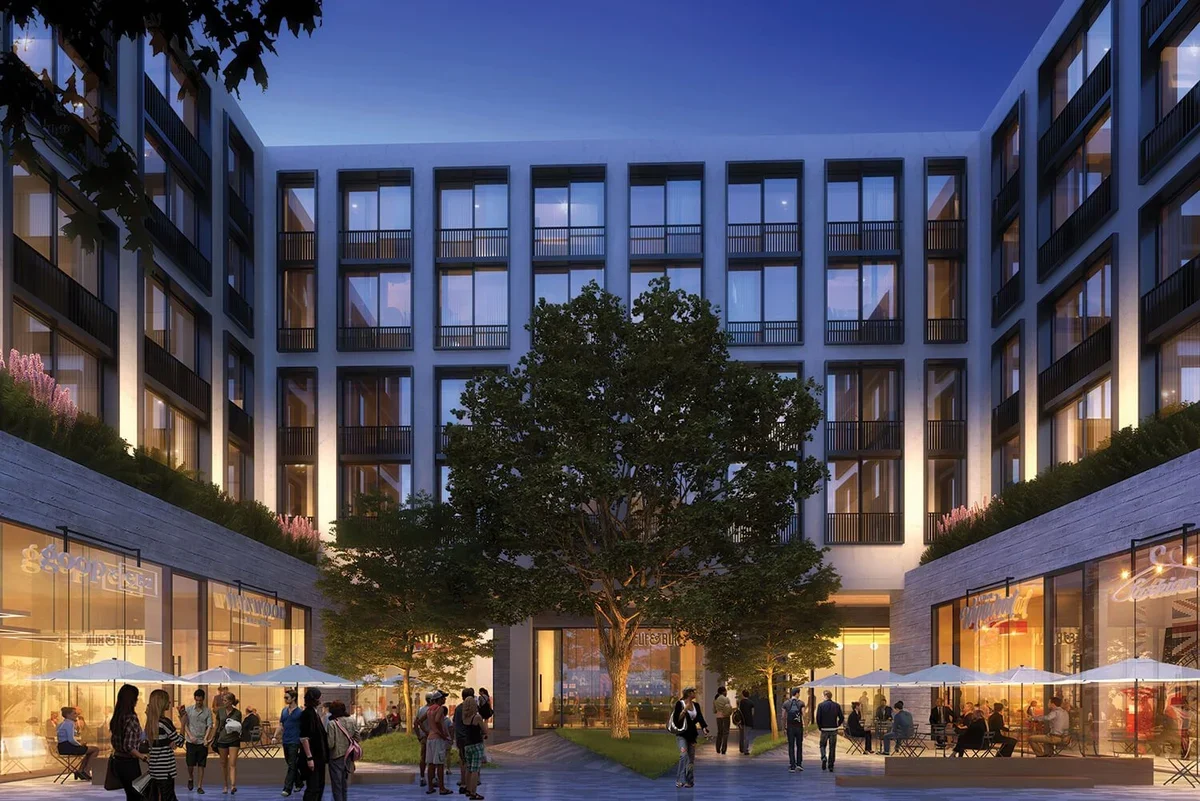 An exterior view of a modern luxury residential or mixed-use building complex with a central courtyard and ground-floor retail spaces,