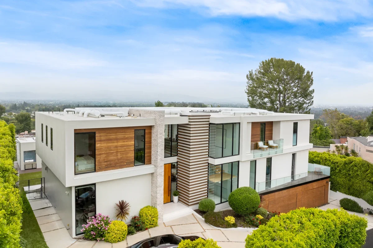 A chic contemporary home surrounded by lush green landscaping