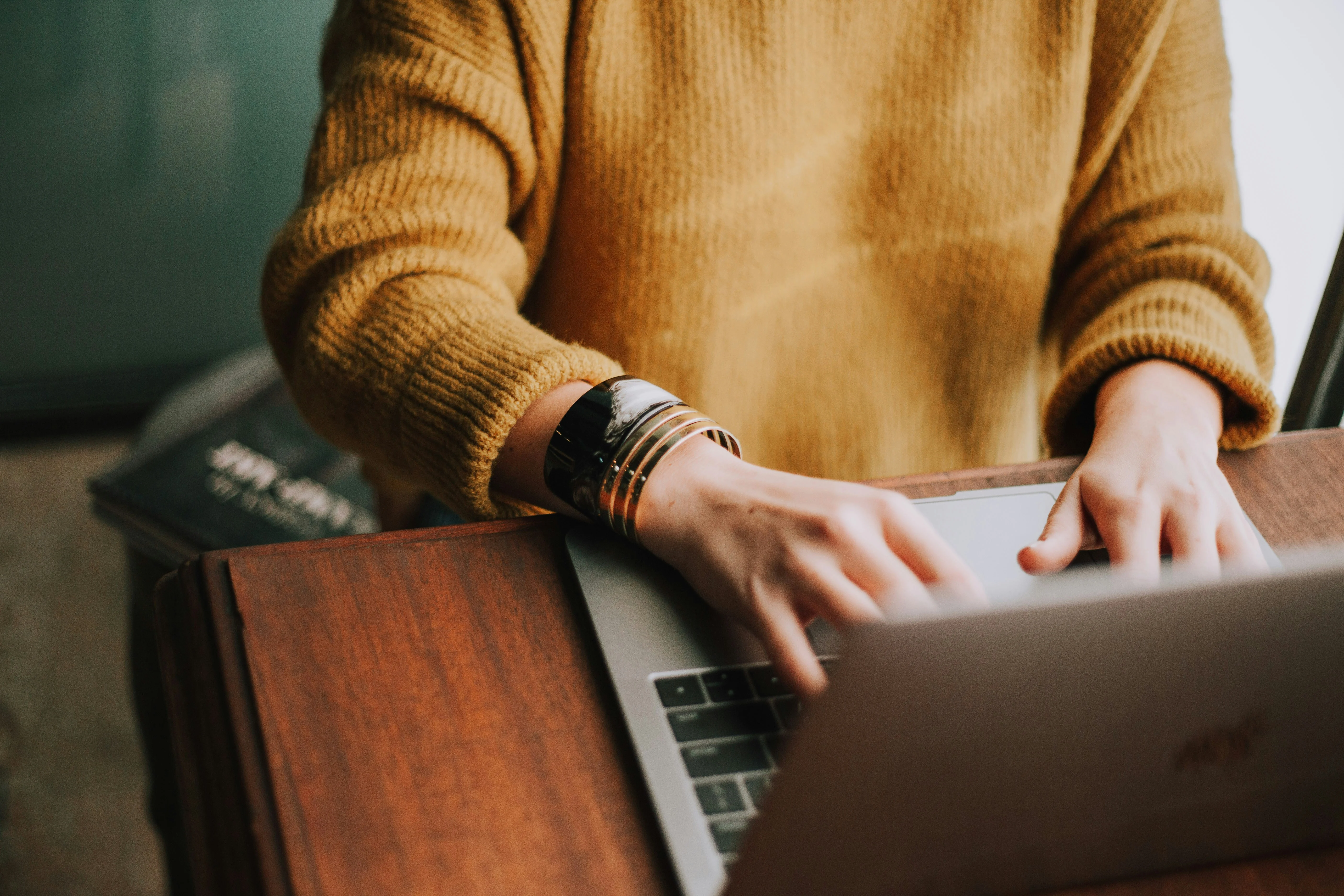 Real estate agent working on laptop with phone