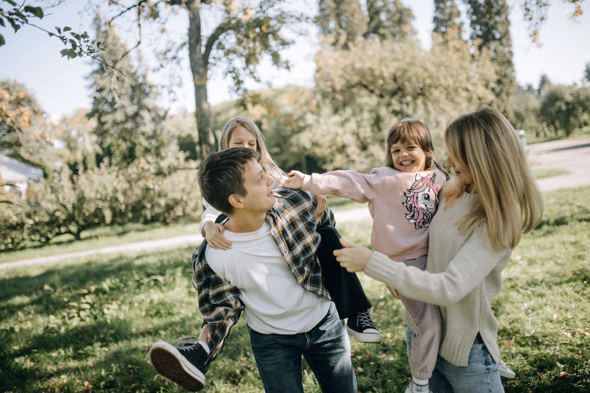A husband, wife, and two frolicking.