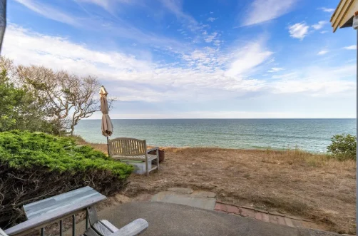 The view from a cement patio looking out over the ocean.